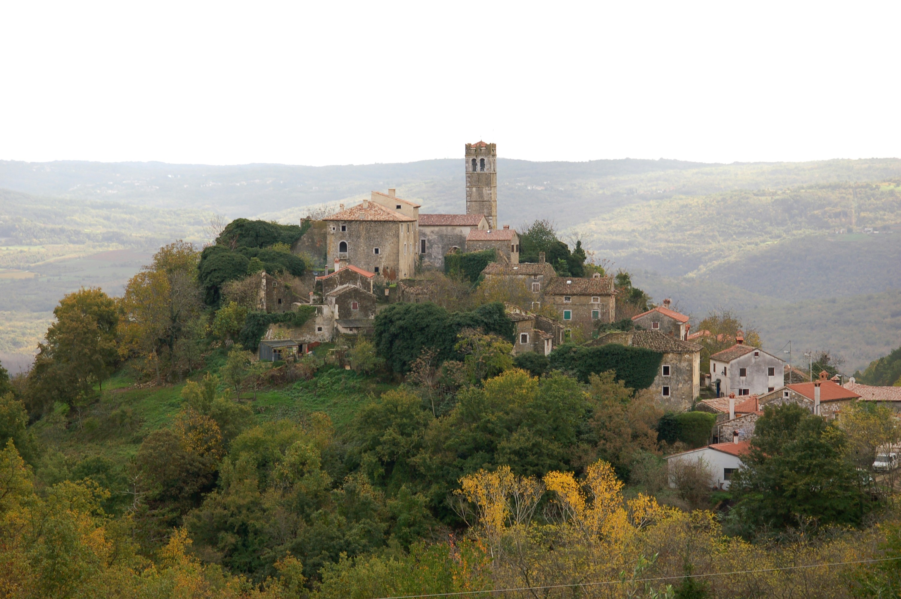 The medieval town of Zavrsje is perched on a hillside in Croatia, the house sand other buildings seeming to pour down from the highest point where the bell tower sits 